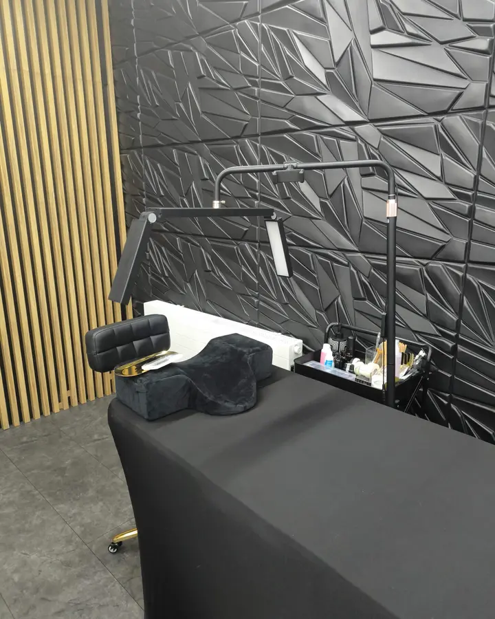 Lash training station in the ProLash Ireland studio: black bed, lash pillow and adjustable lamp